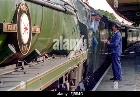 Steam train driving instructor Clive Groom (moustache) with trainees Charlie Johnston (cloth cap) and Bob Baines (black cap). Stock Photo