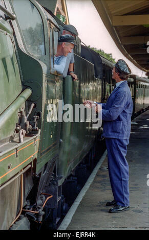 Steam train driving instructor Clive Groom (moustache) with trainees Charlie Johnston (cloth cap) and Bob Baines (black cap). Stock Photo