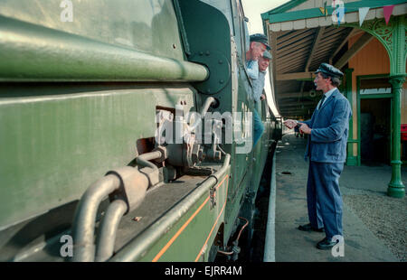 Steam train driving instructor Clive Groom (moustache) with trainees Charlie Johnston (cloth cap) and Bob Baines (black cap). Stock Photo