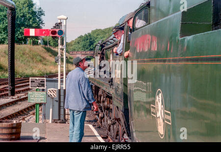 Steam train driving instructor Clive Groom (moustache) with trainees Charlie Johnston (cloth cap) and Bob Baines (black cap). Stock Photo