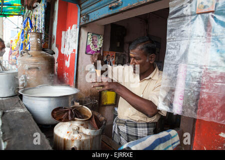 Chai vendor pouring tea in  Mahabalipuram Stock Photo