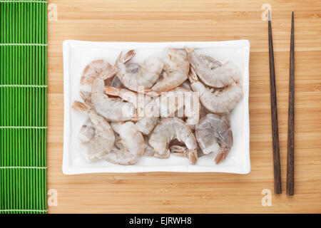 Raw uncooked shrimps plate. On bamboo table Stock Photo