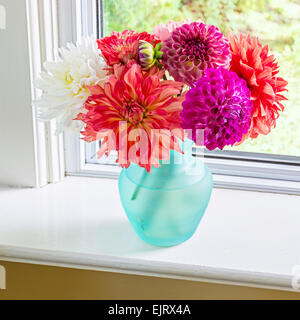 Pretty bouquet of dahlias in a glass vase. Stock Photo