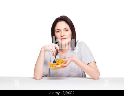 young natural woman looking bored with her healthy meal, isolated on white Stock Photo