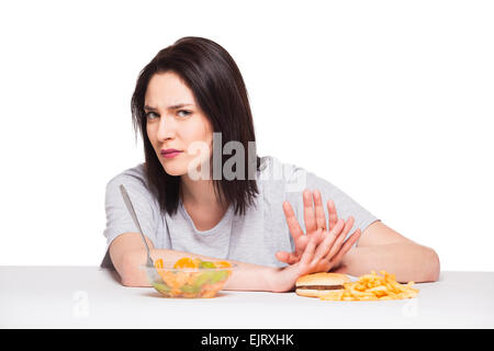 picture of woman with fruits rejecting hamburger Stock Photo