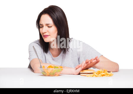 picture of woman with fruits rejecting hamburger Stock Photo