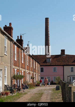 Row of Terraced Brick Cottages, with the EDME Malt Extract Works Chimney behind, Mistley, Essex, England Stock Photo