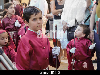 Boy at start of a procession of children, during Holy week, easter, semana santa in Fuengirola, Malaga province, Spain. Stock Photo