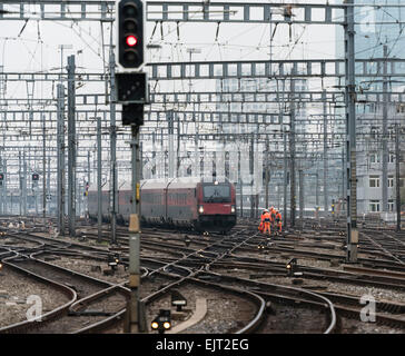 Railway workers and a train on the railway track field of Zurich main station, one of Europe's busiest railway stations. Stock Photo