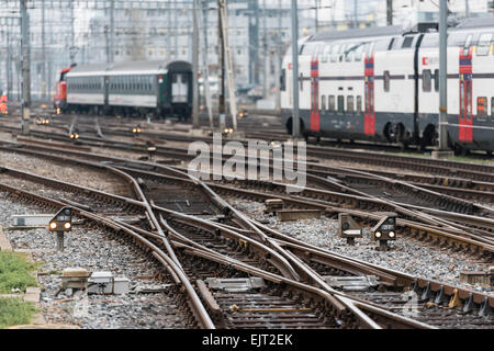 Two trains of Swiss Federal Railways SBB are leaving Zurich's busy main station with its many railway junctions and signals. Stock Photo