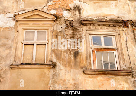 Two broken windows on old  house in historic district, downtown Lviv, Ukraine Stock Photo