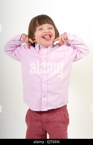 Boy with down syndrome being silly, isolated on white background. Stock Photo