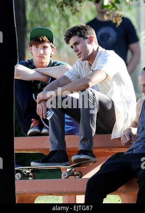 Actor Zac Efron filming a scene for his new movie 'We Are Your Friends'. In the scene he is seen smoking a fake marijuana joint and acting out a drug deal in a park in Encino. Featuring: Zac Efron,Alex Shaffer Where: Encino, California, United States When Stock Photo