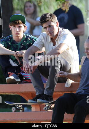 Actor Zac Efron filming a scene for his new movie 'We Are Your Friends'. In the scene he is seen smoking a fake marijuana joint and acting out a drug deal in a park in Encino. Featuring: Zac Efron,Alex Shaffer Where: Encino, California, United States When Stock Photo