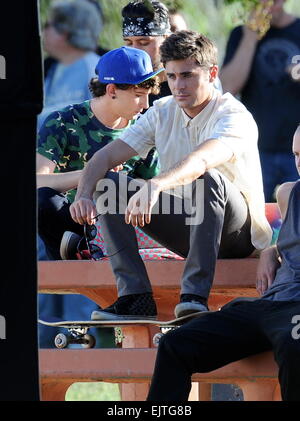 Actor Zac Efron filming a scene for his new movie 'We Are Your Friends'. In the scene he is seen smoking a fake marijuana joint and acting out a drug deal in a park in Encino. Featuring: Zac Efron,Alex Shaffer Where: Encino, California, United States When Stock Photo