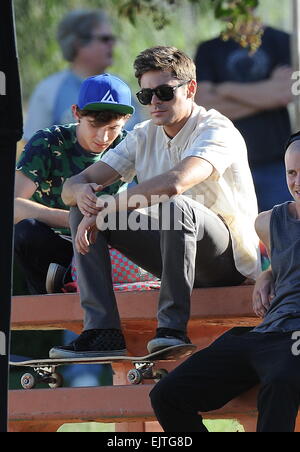 Actor Zac Efron filming a scene for his new movie 'We Are Your Friends'. In the scene he is seen smoking a fake marijuana joint and acting out a drug deal in a park in Encino. Featuring: Zac Efron,Alex Shaffer Where: Encino, California, United States When Stock Photo