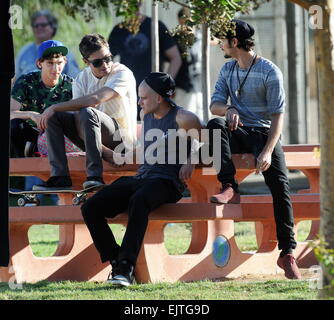 Actor Zac Efron filming a scene for his new movie 'We Are Your Friends'. In the scene he is seen smoking a fake marijuana joint and acting out a drug deal in a park in Encino. Featuring: Zac Efron,Shiloh Fernandez,Jonny Weston,Alex Shaffer Where: Encino, Stock Photo