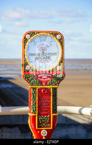 Old style humorous scales on an English seaside pier - very typical of Victorian and Edwardian era Britain; amusement; traditional style amusements Stock Photo