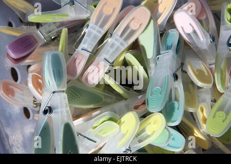 Pile of colourful clothes pegs for hanging washing Stock Photo