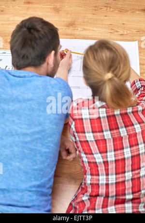 close up of couple with  blueprint at home Stock Photo