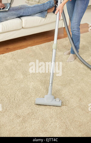 close up of woman legs with vacuum cleaner at home Stock Photo - Alamy