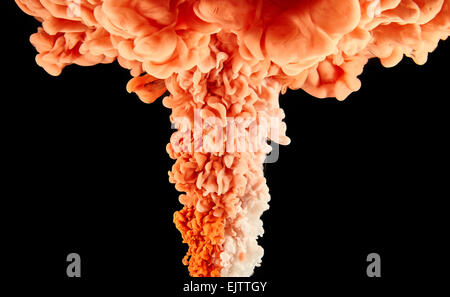 Clay colored ink making swirls in water on black background Stock Photo