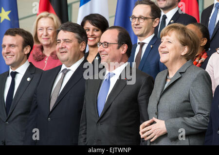 German Chancellor Angela Merkel (front R) and French President Francois Hollande (front 2-R) stand together with members of both governments for a group photo of the 17th German-French Council of Ministers in the Chancellery in Berlin, Germany, 31 March 2015. Among them are, front row: German Minister of Economics and Energy, Sigmar Gabriel (2-L) and his French counterpart Emmanuel Macron (4-L). Second row (L-R): German Minister of Justice and Consumer Protection Heiko Maas and his French counterpart Christiane Taubira. Photo: BERND VON JUTRCZENKA/dpa Stock Photo