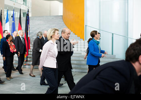 German Defense Minister Ursula von der Leyen (L) and her French counterpart Jean-Yves Le Drian (R) talk to each other after a group photograph in the Chancellery in Berlin, Germany, 31 March 2015. The French President and numerous ministers of his cabinet are in the German capital for the 17th German-French Council of Ministers. Photo: FELIX ZAHN/dpa Stock Photo