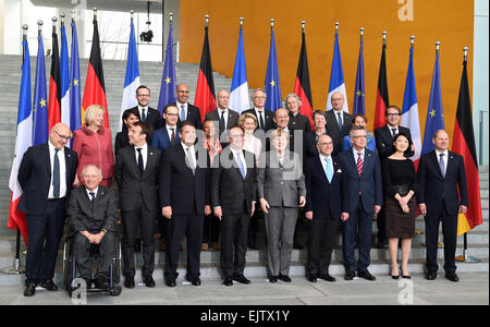 German Chancellor Angela Merkel (C-R) and French President Francois Hollande (C-L) stand together during a group photograph for the 17th German-French Council of Ministers with members of both governments in the Chancellery in Berlin, Germany, 31 March 2015. Among them are, first row (L-R): French Finance Minister Michel Sapin, German Finance Minister Wolfgang Schaeuble, French Economics Minister Emmanuel Macron, German Minister of Economics and Energy Sigmar Gabriel, French President Francois Hollande, German Chancellor Angela Merkel, French Interior Minister Bernard Cazeneuve, German Interi Stock Photo