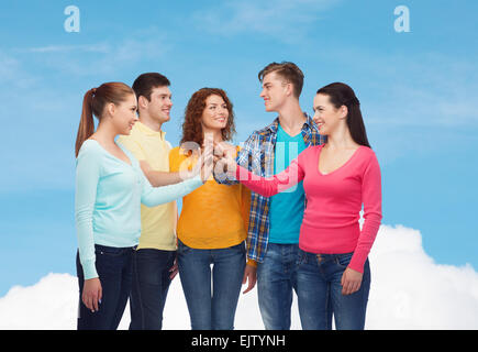 smiling teenagers making high five Stock Photo