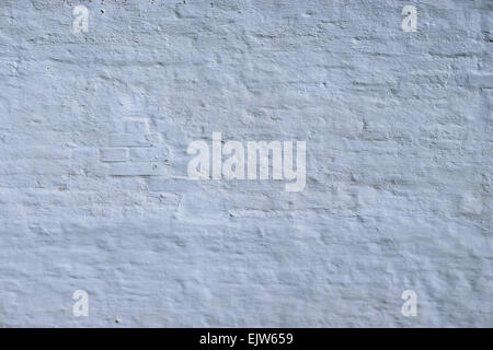 White grunge brick wall background on sunny summer day. Stock Photo