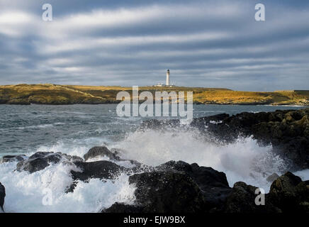 portnahaven lighthouse crashing waves Stock Photo