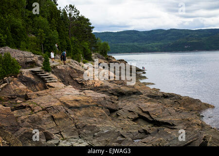 A rocky cliff near the wee village of Sainte-Rose-du-Nord on an inlet of Saguenay Fjord, Quebec, where visitors climb and view. Stock Photo