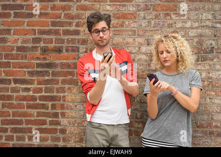 Couple using cell phones Stock Photo