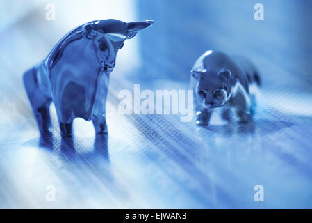 Digital composite with ceramic animals and financial newspaper Stock Photo