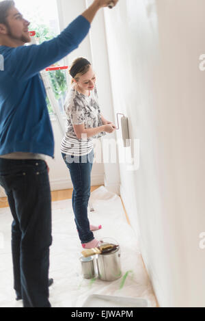 Smiling couple painting wall Stock Photo