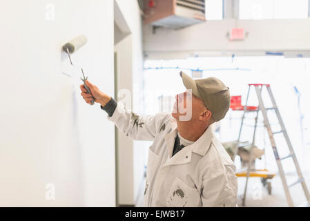 Manual worker painting wall Stock Photo