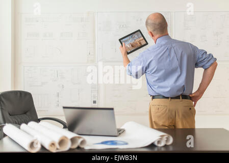 Mature architect using digital tablet in office Stock Photo