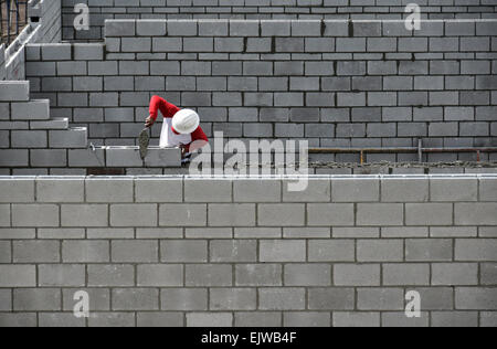 Bricklayer working on brick wall Stock Photo