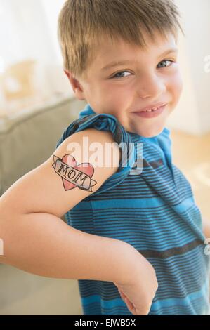 Portrait of boy (6-7) with tatoo on shoulder Stock Photo