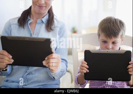 Mother and son (6-7) using digital tablet Stock Photo