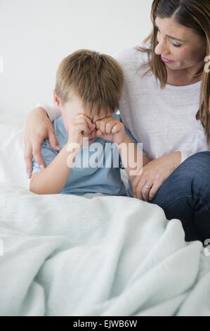 Mother consolling son (6-7) Stock Photo