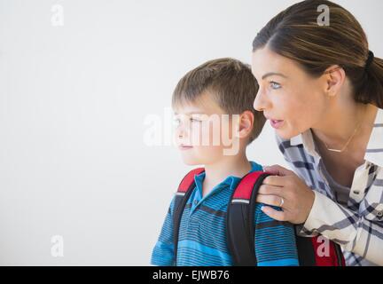 Mother preparing son (6-7) for school Stock Photo