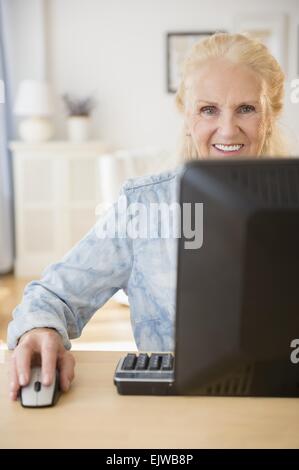 Senior woman using computer Stock Photo