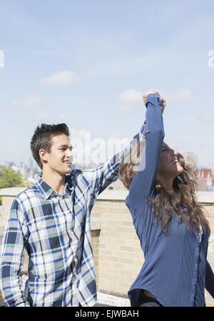 USA, New York State, New York City, Brooklyn, Young couple dancing on roof Stock Photo