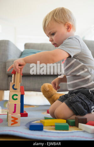 Boy (2-3) playing with blocks in living room Stock Photo
