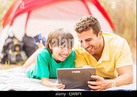 USA, Florida, Jupiter, Father and son (12-13) camping Stock Photo