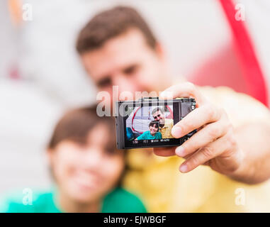 USA, Florida, Jupiter, Father and son (12-13) taking selfie in front of tent Stock Photo