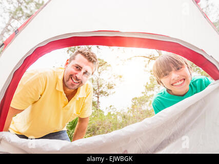 USA, Florida, Jupiter, Portrait of father and son (12-13) looking into tent Stock Photo