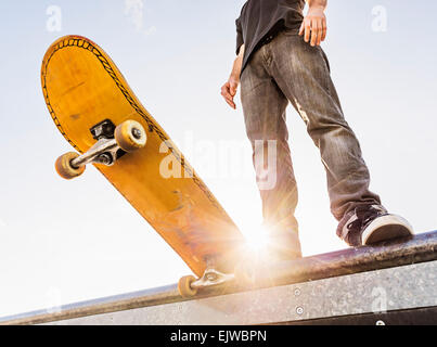 USA, Florida, West Palm Beach, Man with skateboard at the edge of ramp Stock Photo